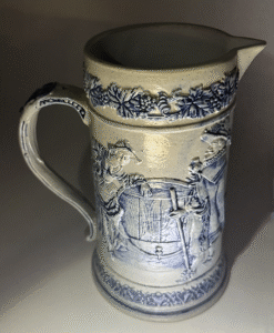 Alternative view of Edelweiss Pitcher, a seated group on one side watching maid and on the other side leaning on a keg of beer.